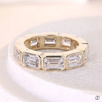 designer wedding band emerald diamond bezel set band
