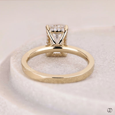 Yellow gold emerald cut diamond ring with hidden halo design

