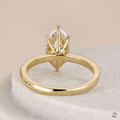 Hidden halo ring beneath marquise diamond setting
