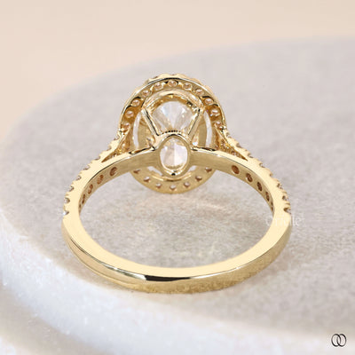 Oval cut diamond ring framed by halo engagement ring
