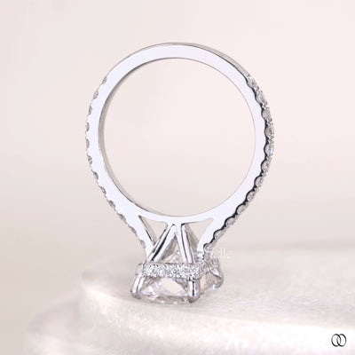 Radiant cut diamond ring with pave diamonds and claw prong setting
