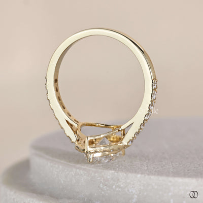 Unique pear cut engagement ring in yellow gold setting
