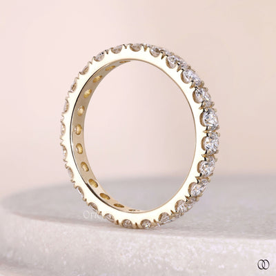 designer round diamond wedding band shared prong band
