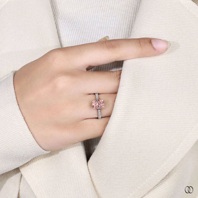 Elongated cushion cut diamond ring with pink diamond accents
