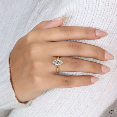 Prong ring securing marquise diamond ring
