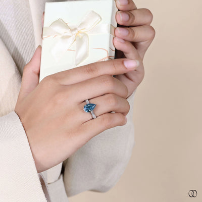 Lab grown pear shaped diamond ring with hidden halo engagement design

