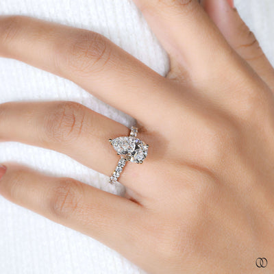 Yellow gold engagement ring with pear diamond centerpiece
