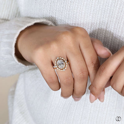 Yellow gold engagement ring with oval diamond centerpiece
