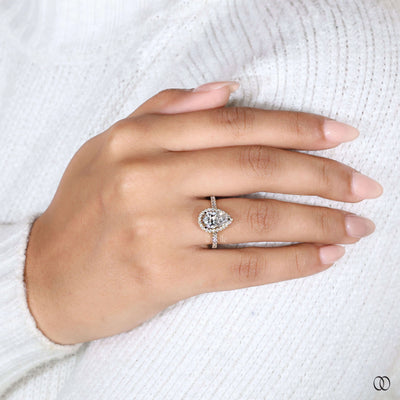 Halo diamond ring highlighting elegant pear engagement ring
