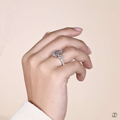 Unique pear cut diamond engagement ring with pave set band
