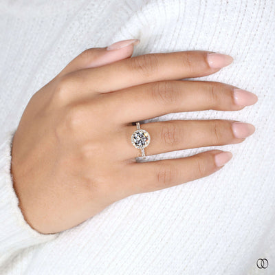 Halo engagement ring highlighting round brilliant diamond
