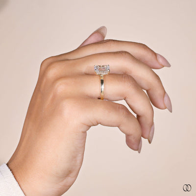 Emerald cut diamond engagement ring with hidden halo in gold
