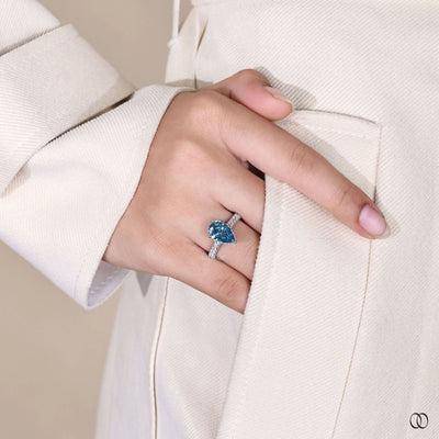 Pear shaped diamond engagement ring with pave diamonds and halo
