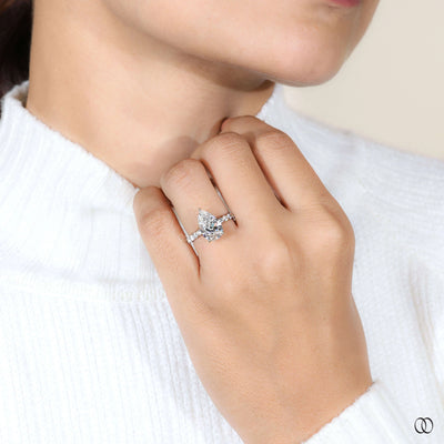 Cathedral ring showcasing pear diamond engagement ring
