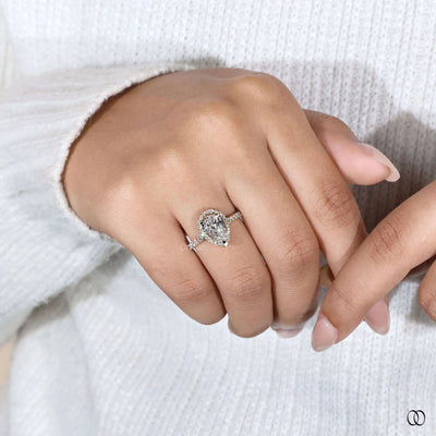 Prong setting ring securing a pear cut engagement ring
