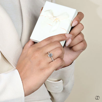 Pave engagement ring paired with emerald cut diamond
