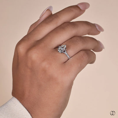 Pear cut diamond engagement ring with a white gold pavé band
