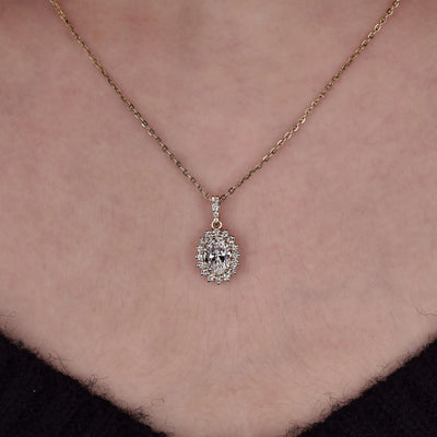 Yellow gold pendant with a polished finish and classic diamond details
