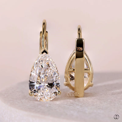 Three prong diamond earrings with a delicate setting
