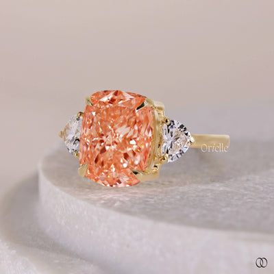 Orange Cushion Cut Ring With Side Trillion Stone
