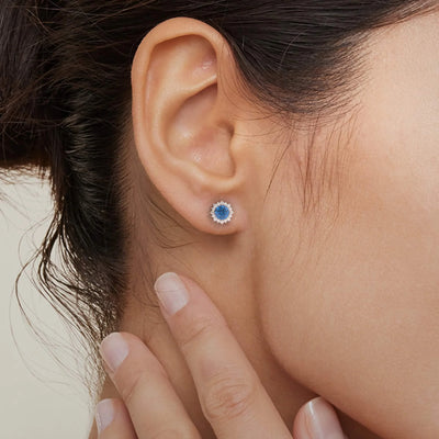 Blue sapphire and moissanite halo earrings in gold finish
