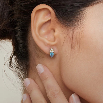 Pear cut blue sapphire earrings paired with moissanite studs
