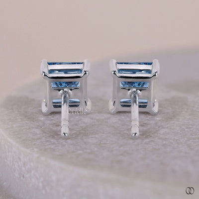 Basket setting earrings with elegant details and secure gemstone placement
