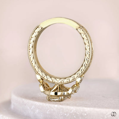Marquise engagement ring with ornate frame halo design
