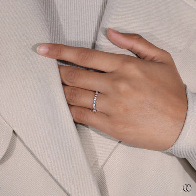 round moissanite wedding band shared prong style
