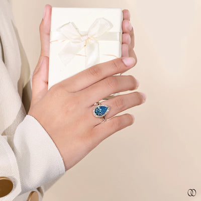 blue diamond ring cathedral halo design
