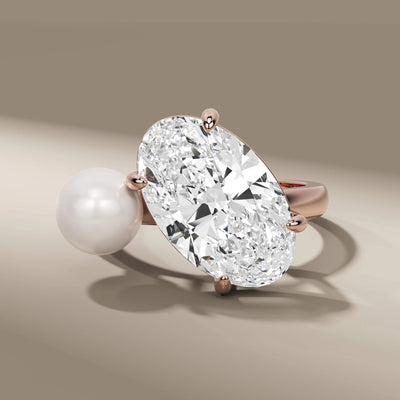 handmade engagement ring featuring oval and pearl stones
