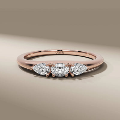 yellow gold ring with three stone oval and pear diamond center
