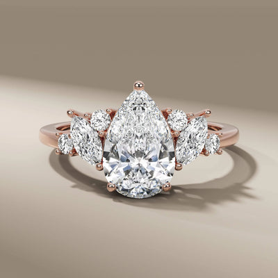 Unique pear diamond ring with round and marquise side details
