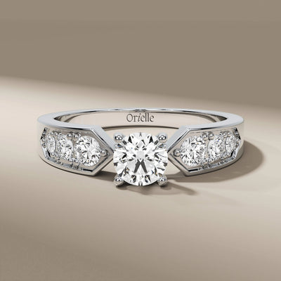 handmade ring featuring round cut center and side stones
