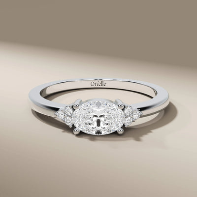designer promise ring with oval diamond and side stones
