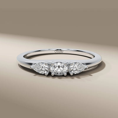 handmade three stone ring with oval and pear cut diamonds
