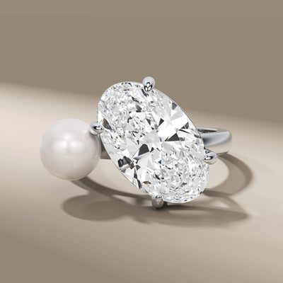 unique design ring with oval cut diamond and pearl center
