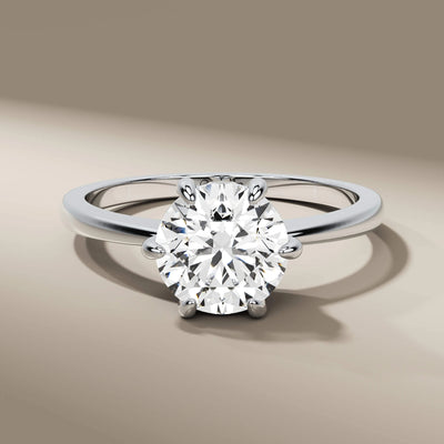 unique design ring showcasing round diamond in yellow gold
