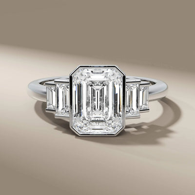 handmade ring with emerald cut diamond and bezel setting
