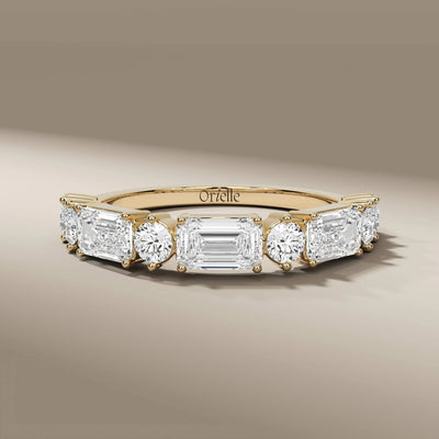 emerald diamond half eternity wedding band in yellow gold
