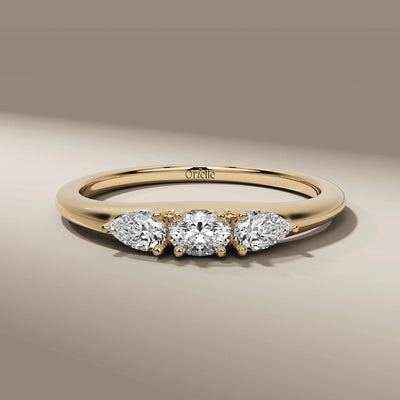 three stone diamond ring with oval and pear cut diamonds
