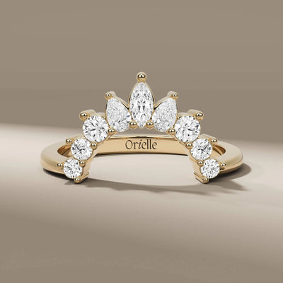 curved wedding band with marquise pear and round diamonds
