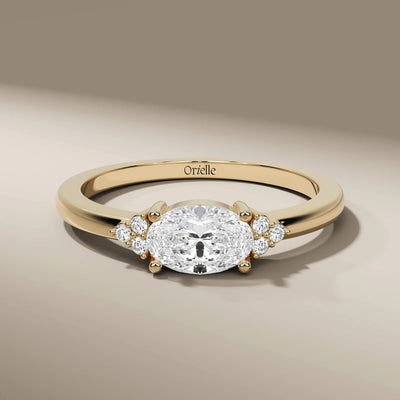 oval diamond ring with round side stones in prong setting
