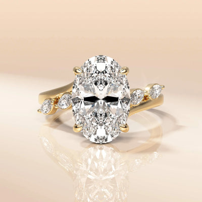 Cathedral setting oval cut engagement ring in yellow gold
