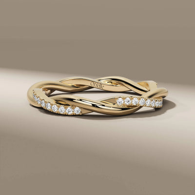 twisted yellow gold wedding band with round cut diamonds
