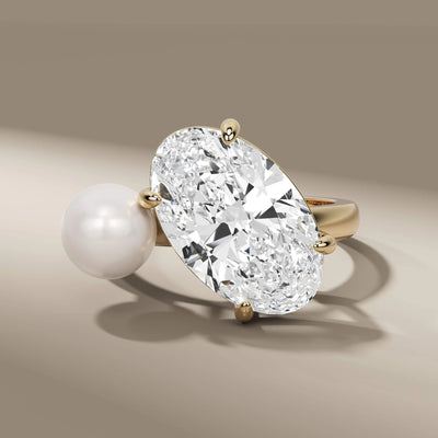 oval and pearl engagement ring in elegant 4 claw prong setting

