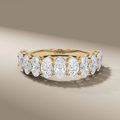 oval diamond wedding band in yellow gold shared prong style
