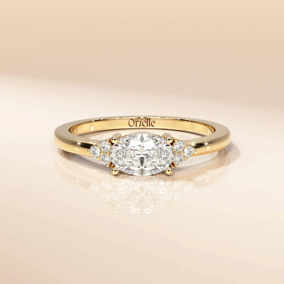 Gold oval moissanite engagement style ring
