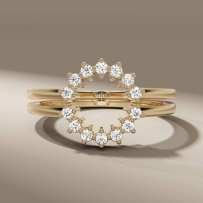 Round cut wedding band with yellow gold prong setting and halo detail
