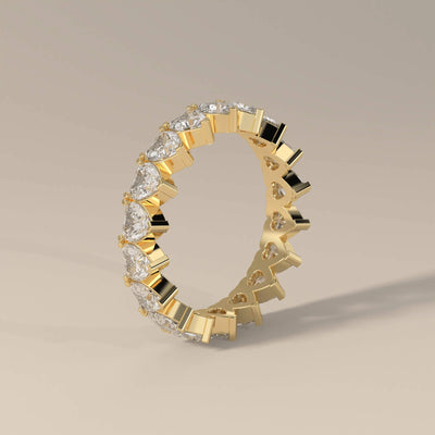 Heart shaped wedding band in yellow gold with prong setting
